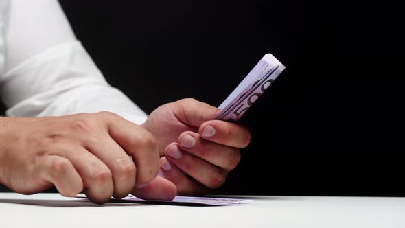 Counting Five Hundred Euro Banknotes on Black Background