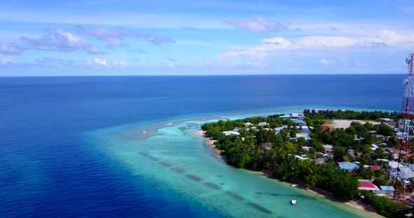 Wide overhead island view of a sunshine white sandy paradise beach and aqua turquoise water backgrou