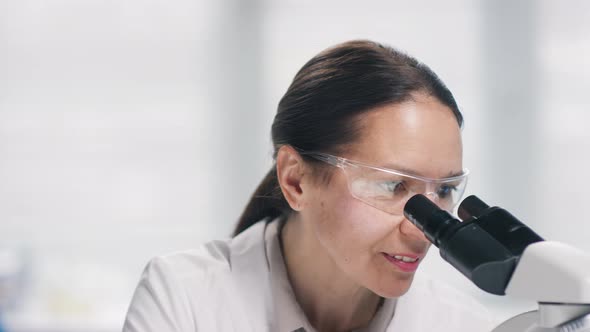 Portrait of Cheerful Female Microbiologist in Lab