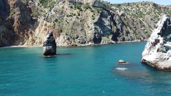 Aerial View From Above on Azure Sea and Volcanic Rocky Shores