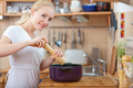 young woman cooking in the kitchen- adding salt and pepper into the pot seasoning concept - PhotoDune Item for Sale