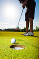 closeup shot of golf ball with golf club right before tee off - PhotoDune Item for Sale