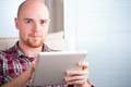 Focused man working and playing with tablet computer (lots of copyspace) - PhotoDune Item for Sale