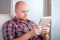 Focused man working and playing with tablet computer (lots of copyspace) - PhotoDune Item for Sale