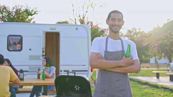 Portrait of attractive man traveler look at camera, standing outdoor enjoy holiday picnic party.