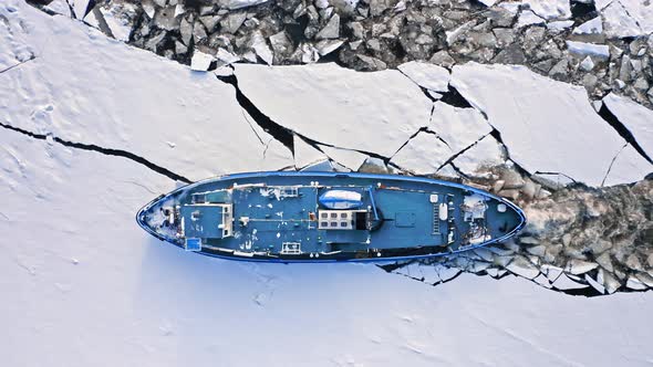 Icebreaker on Vistula river crushing ice in winter, Plock, Poland