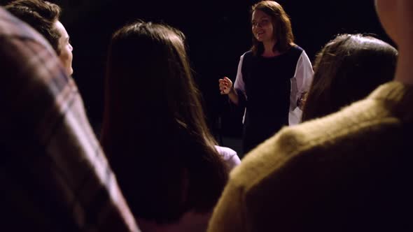 Teenagers rehearsing in a theatre