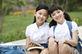 Portrait of schoolgirls in uniform sitting on steps side by side - PhotoDune Item for Sale