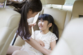 Mother fastening seat belt for daughter - PhotoDune Item for Sale