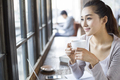 Young woman drinking coffee in cafe - PhotoDune Item for Sale