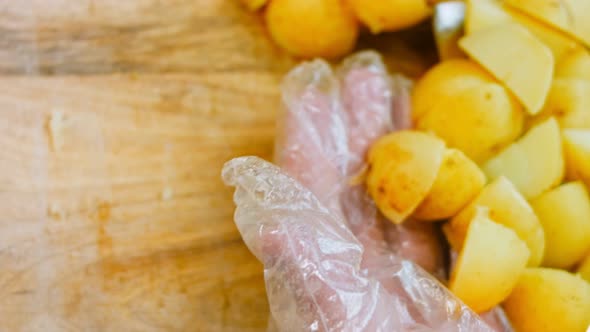 The Chef Cuts the Freshly Boiled Potatoes with a Professional Knife