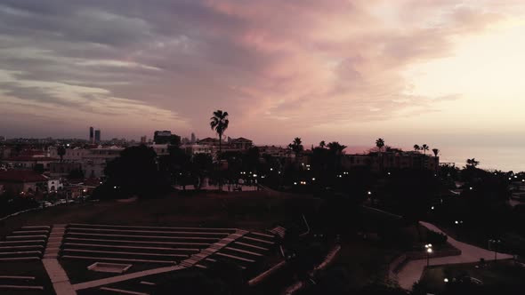 A drone flying through the amphetheater to the sunset at Jaffo 4K