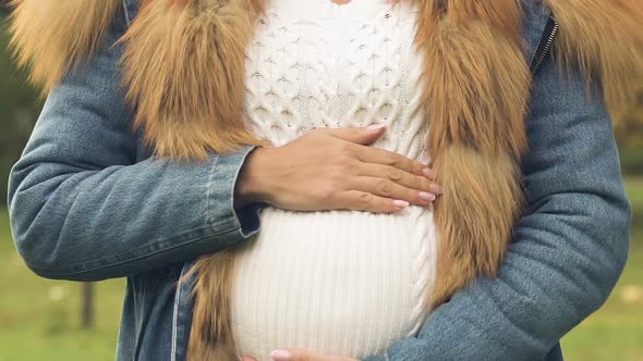 Happy Pregnant Woman Stroking Belly, Caring About Child, Walking in Fresh Air