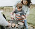 Mother assisting her child while grilling - PhotoDune Item for Sale