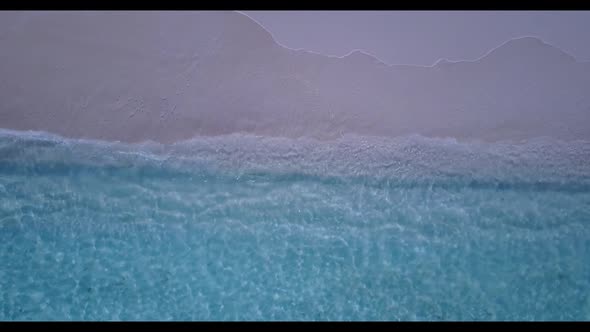 Aerial drone shot texture of paradise seashore beach voyage by blue ocean with white sand background