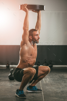 bell. Strong male doing crossfit workout.