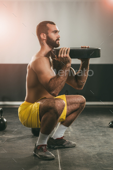 bell. Strong male doing crossfit workout.