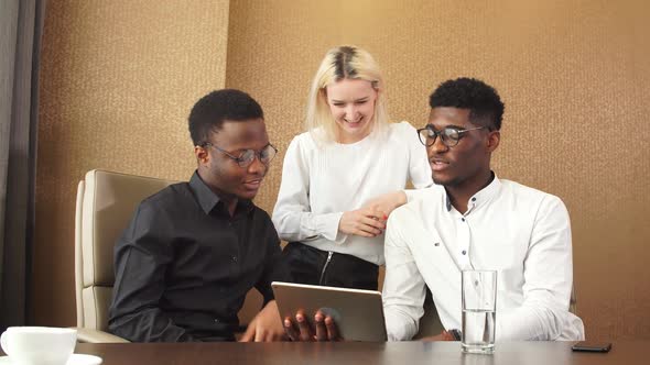 Afro Guy and His Co-workers Making Up a Plan