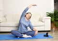 Mature woman doing yoga at home - PhotoDune Item for Sale