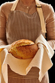 Baker holding loaf of homemade bread - PhotoDune Item for Sale