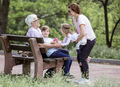 Three generation family in summer park: grandfather, mother, and grandchildren. - PhotoDune Item for Sale