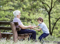 Mature man and his granson playing in summer park. - PhotoDune Item for Sale