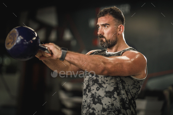 kettlеbell swing exercises at the gym.