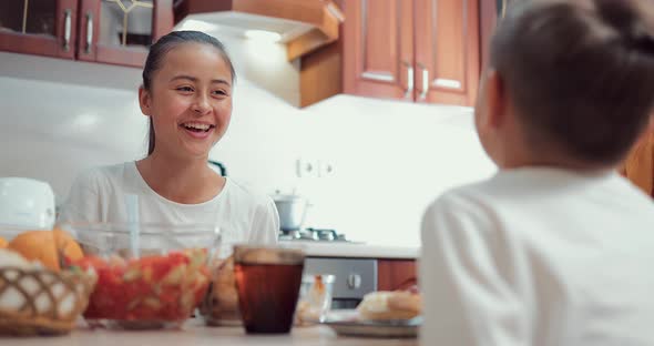 Beautiful Oriental Girl Having Dinner with Family