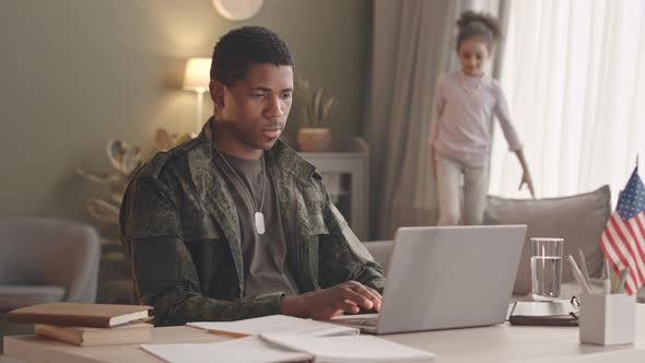 African American Soldier Working on Laptop from Home alt