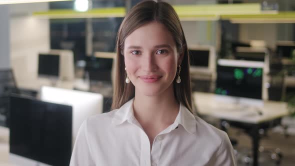 Portrait of Beautiful Young Woman Wearing White Shirt Looking Up to the Camera and Smiling