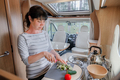 Woman cooking in camper, motorhome interior - PhotoDune Item for Sale