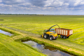 Tractors on fresh mowed green agricultural grassland - PhotoDune Item for Sale