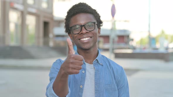 Thumbs Up By Young African Man Standing Outdoor