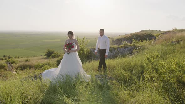 Groom Walks to His Bride in the Green Plants