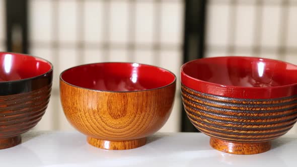 Variation of Japanese wooden lacquered bowls in a row 