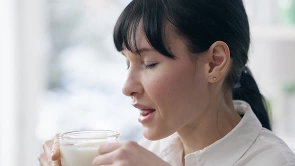 Closeup of Confident Young Businesswoman Enjoying Morning Cappuccino at Home or in Office