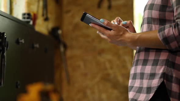 Female Business Owner Using Digital Tablet in Workshop