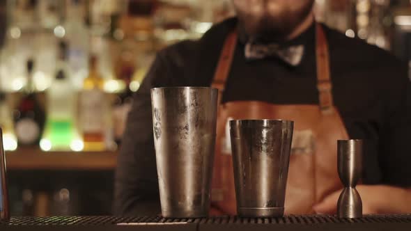 Close Up Shot of Bar Counter Where There Are Metal Cups for Mixing Cocktail