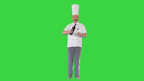 Senior Man Cook Tasting Red Wine on a Green Screen Chroma Key