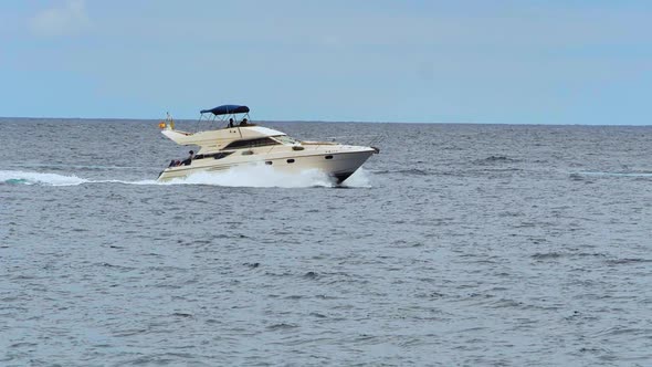 Slow-motion shot of a yacht sailing in the ocean