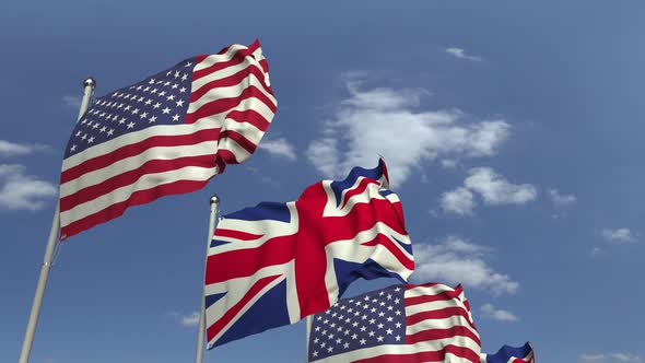 Waving Flags of Britain and the USA on Sky Background