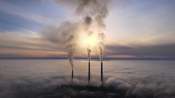 Aerial View of Coal Power Plant High Pipes with Black Smoke Moving Up Polluting Atmosphere at Sunset
