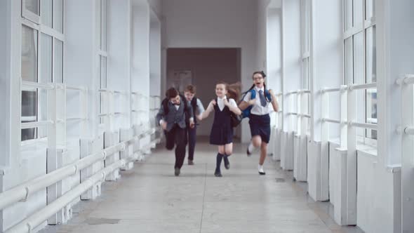 Excited Schoolchildren Running in Hallway