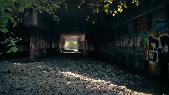 Flying Under Industrial Bridge With Graffiti