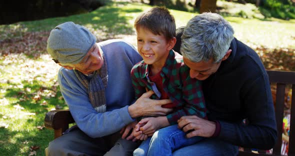 grandfather father and son laughing outdoors