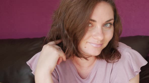 Closeup Portrait of a Young Beautiful Woman with Green Eyes and Dark Hair Who Looks Directly Into