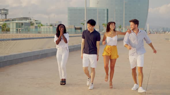 Group of Young Smiling Young People of Different Races Skipping Happily Together Outdoors