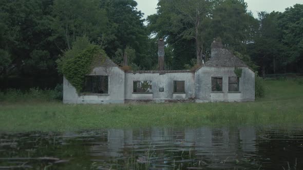 Derelict bungalow house sits on river shoreline