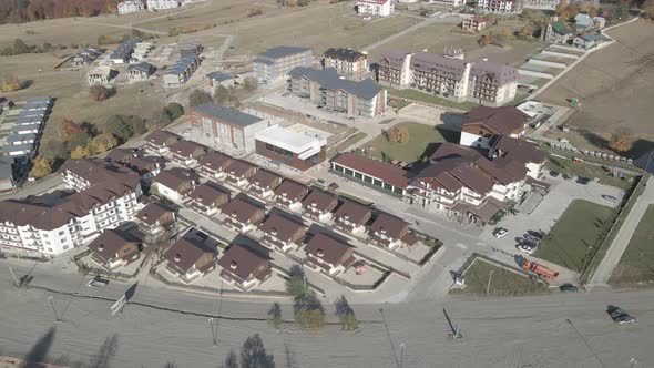 Flying over mountain resort Crystal in Bakuriani. Modern hotel in Georgian mountains.