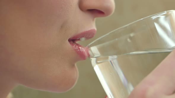 Young Woman Drinking Water From a Glass